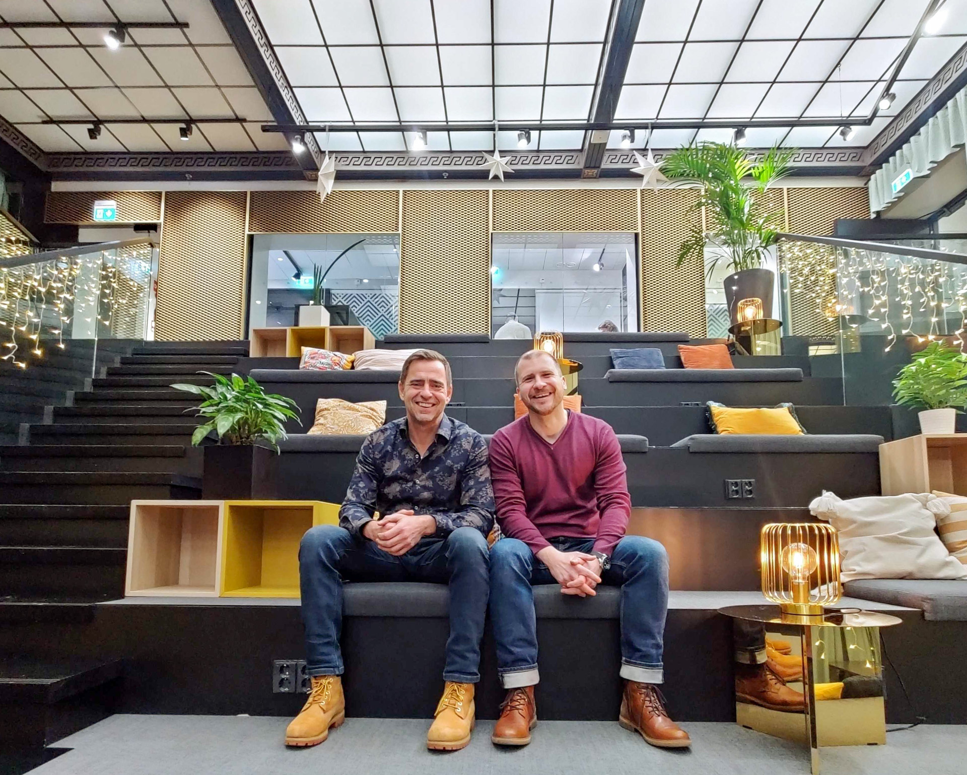 Epicenter Helsinki's Country manager Kristian Nieminen and Spouse Program's project coordinator Jochen Faugel sitting on the stairs of Epicenter Helsinki's lounge.